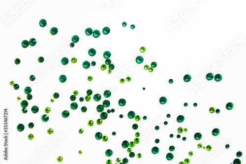 Bild auf Leinwand green rhinestones on a white background, top photo