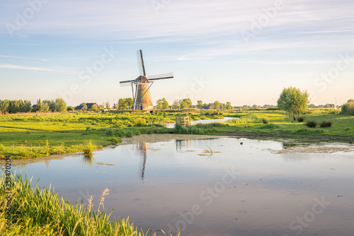 Picturesque view of a traditional windmill in the dutch countryside © Menyhert