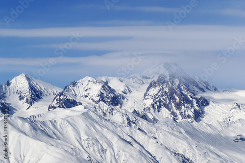 High snowy mountains and blue sky with clouds © BSANI