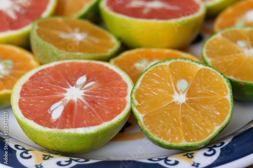 Beautiful lemons  bergamots and grapefruits cut in half on a cutting board.