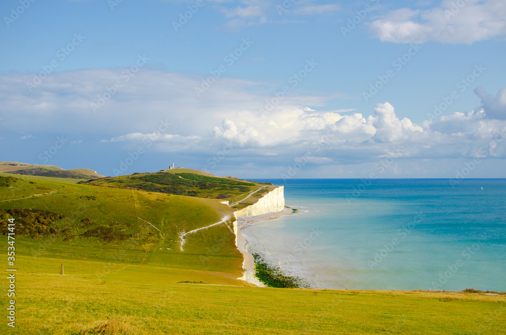 Seven sisters cliffs in England on the sunny day in summer. Chalk cliffs and azure water. English landscape.