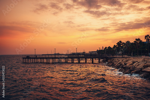 Dramatic sunset in Cyprus. Limassol pier and evening sea. Mediterranean landscape.