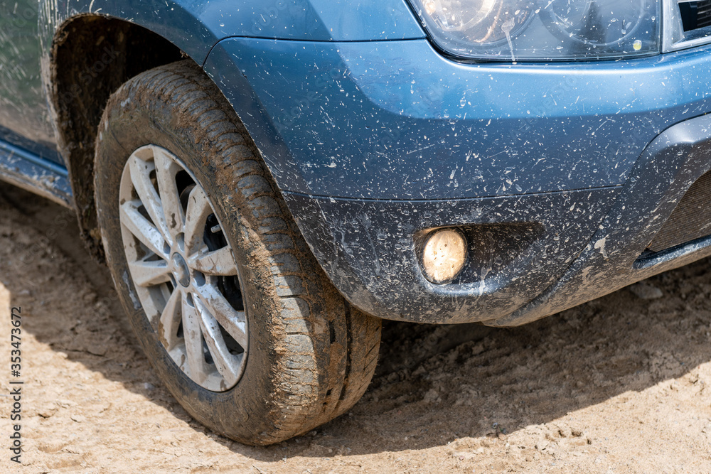 Dirty car wheel closeup in a countryside road. Off road concept. 4x4 Dirty car wheel closeup in a countryside road. Off road concept. 4x4