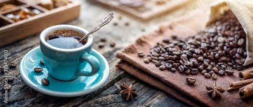 A blue cup of aromatic black coffee and coffee beans on the table. Morning Coffee Espresso for breakfast in a beautiful blue cup. © Tryfonov