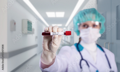 Female doctor in a hospital holding the COVID positive blood sample. Vaccine research concept