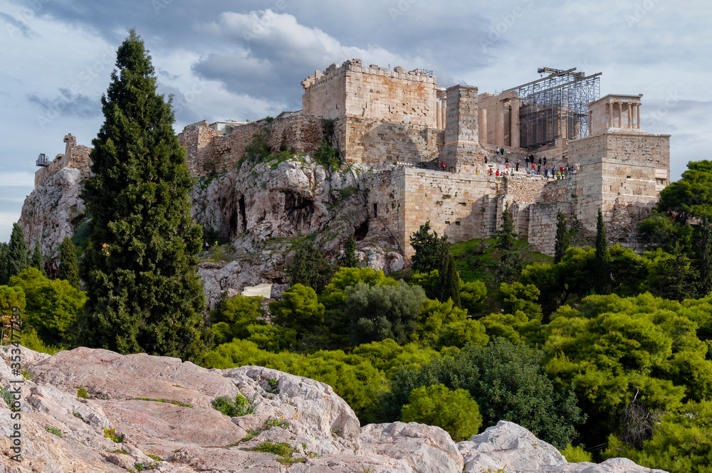 The Acropolis of Athens city in Greece with the Parthenon Temple (dedicated to goddess Athena) as seen from the vantage point of Areopagus Hill in Plaka district on a sunny day with cloudy sky