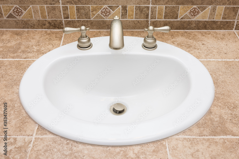 Fototapeta premium White drop in sink on tiled counter