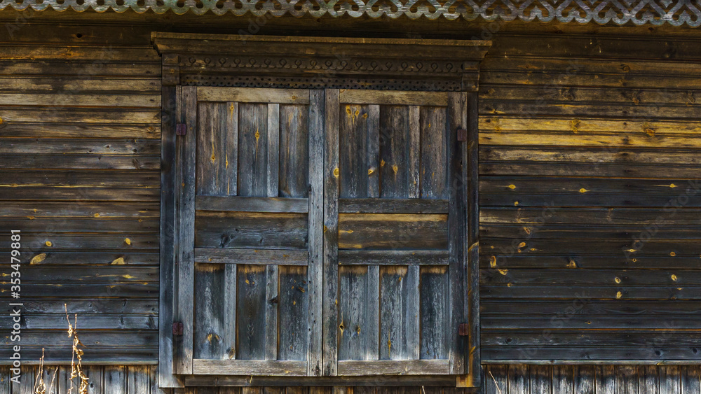 Rustic house wall with closed window and cracked paint. Space for text. Countryside concept. Rustic house wall with closed window and cracked paint. Space for text. Countryside concept.