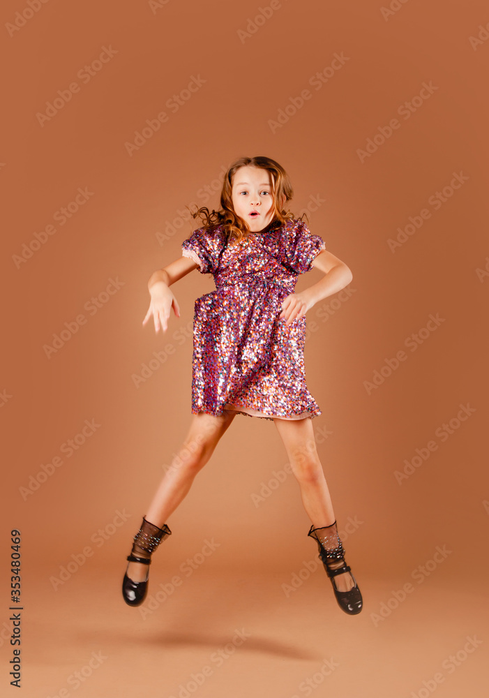 beautiful girl in a pink sequin dress bounces into the air beautiful girl in a pink sequin dress bounces into the air