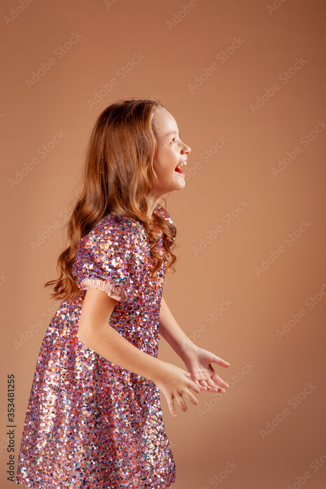 cute girl in the sequin dress turned sideways and laughs contagiously cute girl in the sequin dress turned sideways and laughs contagiously