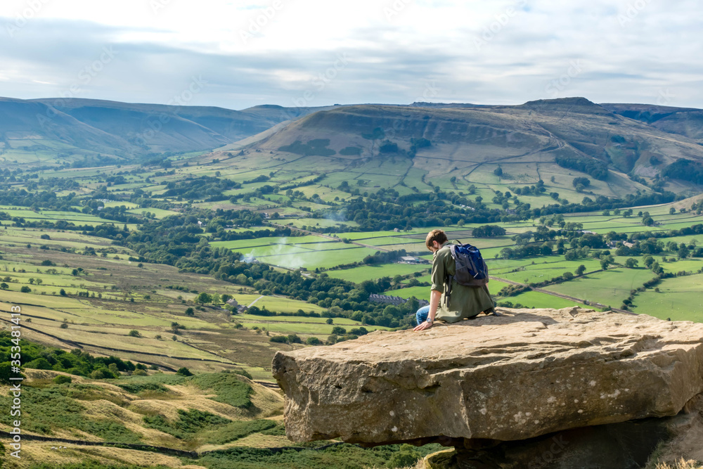 Tourist sitting on the rock, Valley in Peak Distrikt, UK