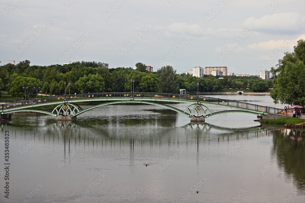 Moscow / Russia – 07 16 2019: Empty large green bridge in Tsaritsyno Park Museum on summer day, view from water Dam on Vozdushnaya street