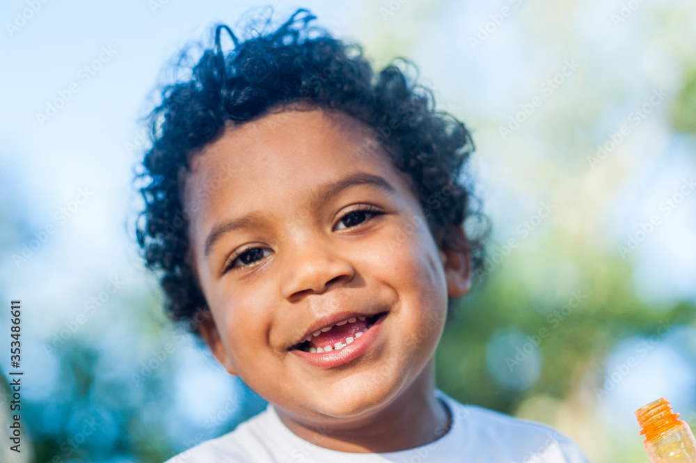 Afro american young boy smiling at the camera. Afro american young boy smiling at the camera.
