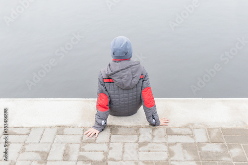  A little boy walks along the embankment