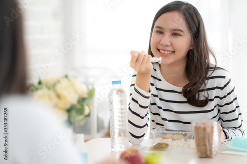 Beauty Young Asian woman eating lunchbox set with friend.