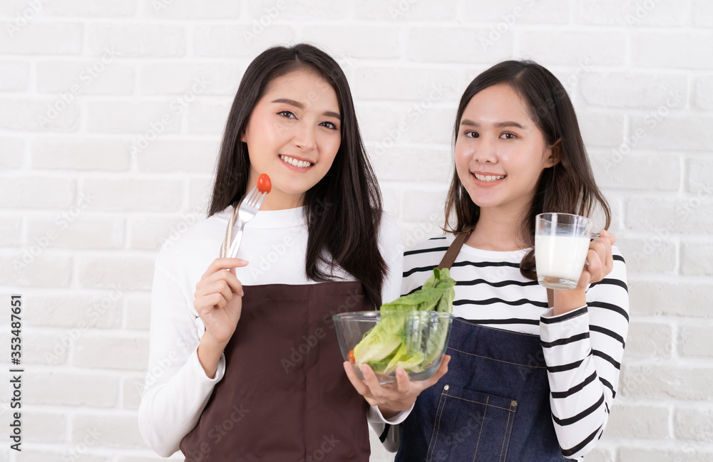 Young Beauty Asian women eating fresh salad and drink fresh milk Young Beauty Asian women eating fresh salad and drink fresh milk