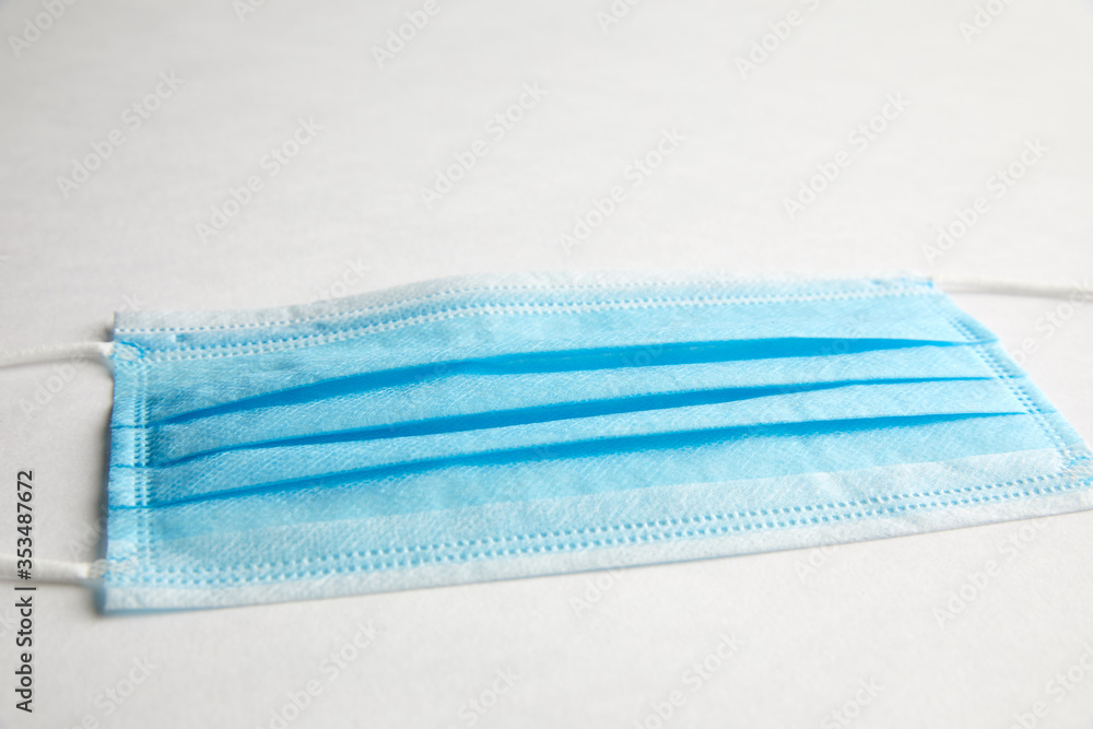 A simple isolated studio shot of of a blue surgical face mask that protects against coronavirus A simple isolated studio shot of of a blue surgical face mask that protects against coronavirus