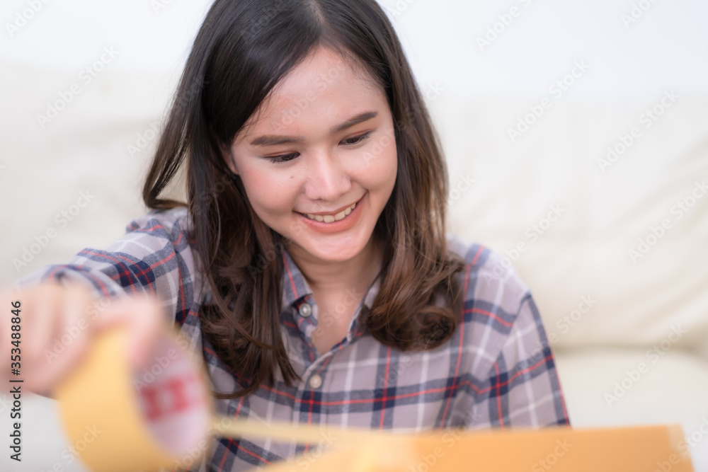 Two Asian female packing product and usng tablet to checking order from customer shopping online and e-commerce at small office. Two Asian female packing product and usng tablet to checking order from customer shopping online and e-commerce at small office.