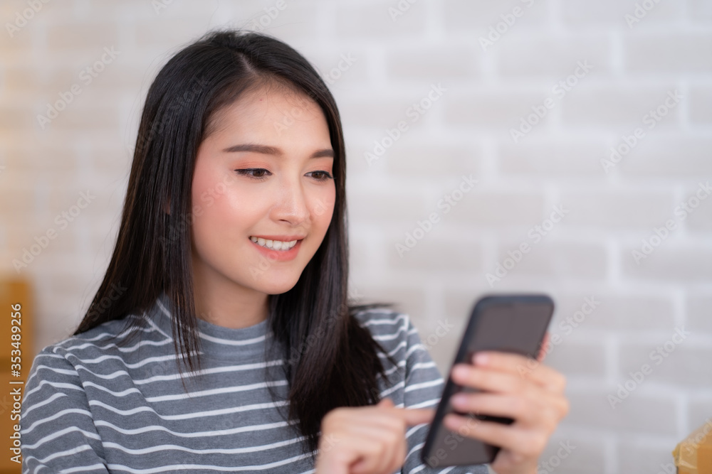 Close up of Asian woman working with tablet and smiling. Close up of Asian woman working with tablet and smiling.