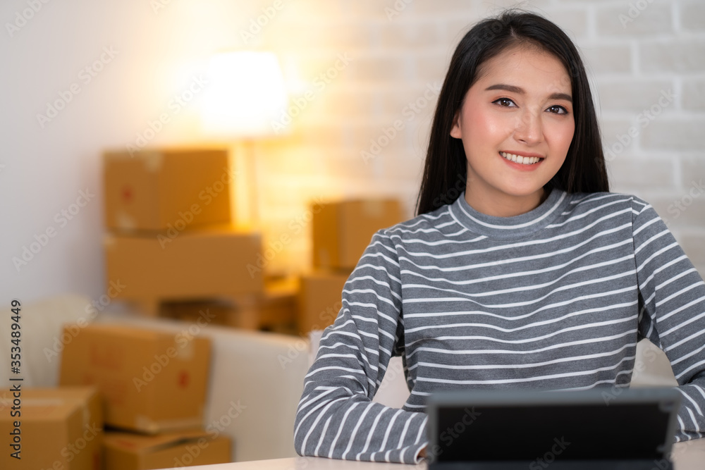 Close up of Asian woman working with tablet and smiling. Close up of Asian woman working with tablet and smiling.