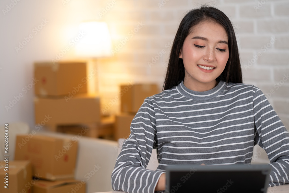 Close up of Asian woman working with tablet and smiling. Close up of Asian woman working with tablet and smiling.