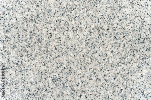 The surface texture of a gray natural granite slab.