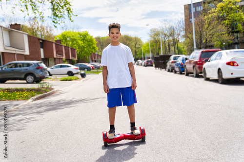 Beautiful Portrait of a Black Boy Running a Mini Electric Scooter