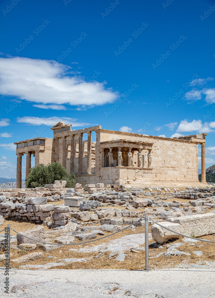 Obraz premium Athens, Greece. Erechtheion with Caryatid Porch on Acropolis hill, blue sky background