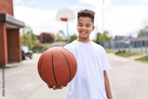 cute Afro american players playing basketball outdoors