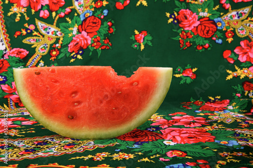 A slice of watermelon in traditional background 
