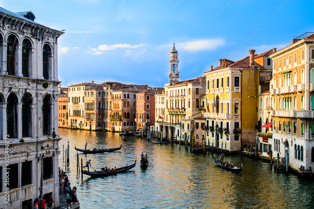 Venice, ITALY - AUGUST 12: Gondoliers tranporting tourists on August 12th 2014 in Venice, Italy.