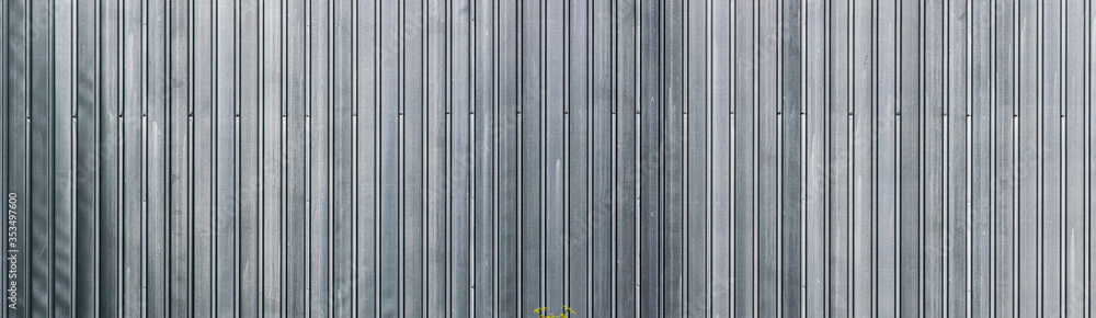 panoramic view of profiled sheet metal wall. Gray metal texture surface. Seamless background. panoramic view of profiled sheet metal wall. Gray metal texture surface. Seamless background.