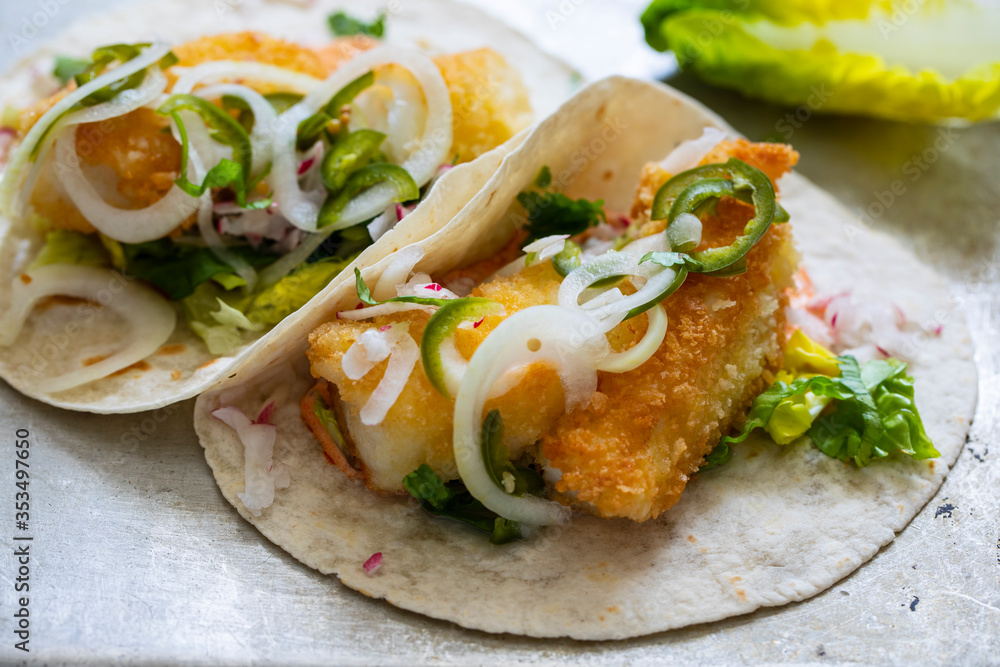 Fish tacos with cod, harrisa sauce, pickled onions and chili Fish tacos with cod, harrisa sauce, pickled onions and chili