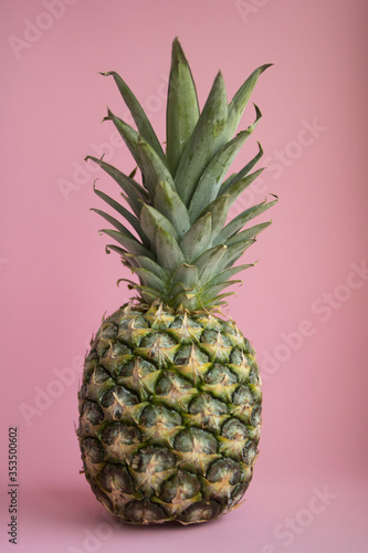 Beautiful tasty fresh pineapple on a delicate pink background 