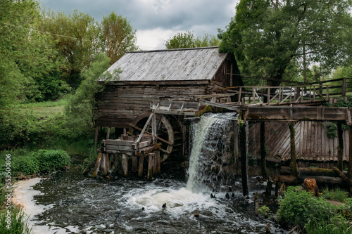 Obraz na płótnie Old wooden log watermill in Russian village
