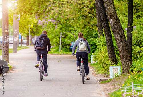 Wallpaper Mural Cyclists ride on the bike path in the city street Torontodigital.ca