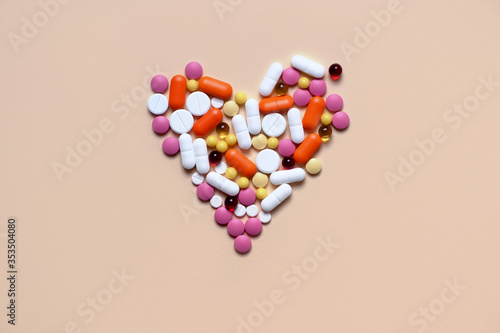Medical concept. Assorted pharmacological preparations, tablets and pills in the shape of a heart. Treatment with pills. Place for text