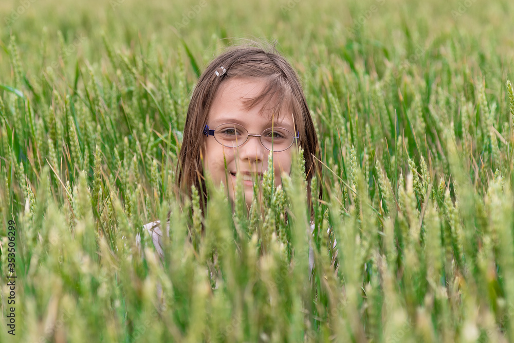 Cute girl farmer in wheat field. Portrait of a girl in a wheat field. Cute girl farmer in wheat field. Portrait of a girl in a wheat field.
