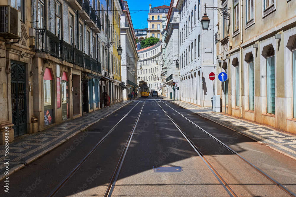Empty streets with tram rails and overhead lines in Lisbon, Portugal.