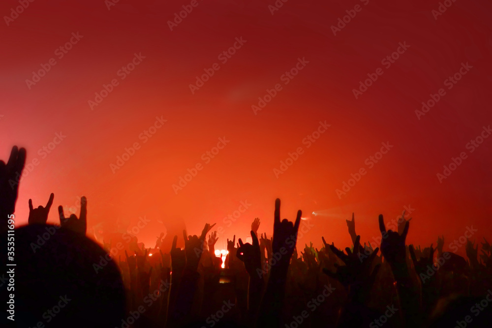 Fans. Red light. Crowd. Music event place for text. Hands up copy space. Night life place for text. Concert pattern for design. Musical background. Fans. Red light. Crowd. Music event place for text. Hands up copy space. Night life place for text. Concert pattern for design. Musical background.