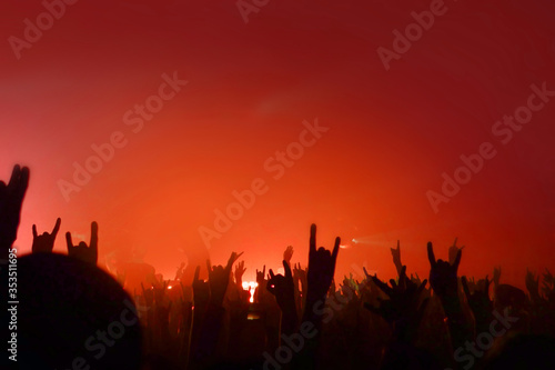 Fans. Red light. Crowd. Music event place for text. Hands up copy space. Night life place for text. Concert pattern for design. Musical background.