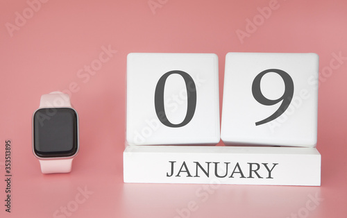 Modern Watch with cube calendar and date 09 january on pink background. Concept winter time vacation.