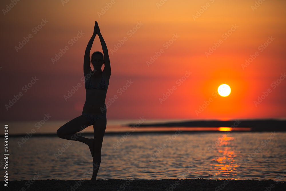 Vrikshasana tree pose from yoga by woman silhouette on sunset Stock ...