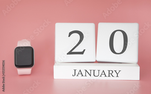 Modern Watch with cube calendar and date 20 january on pink background. Concept winter time vacation.