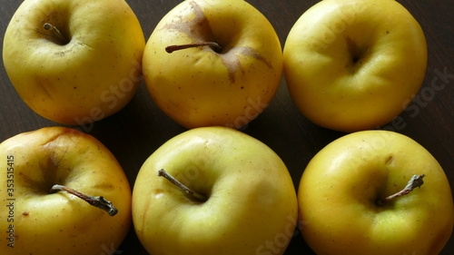yellow apples on a dark background