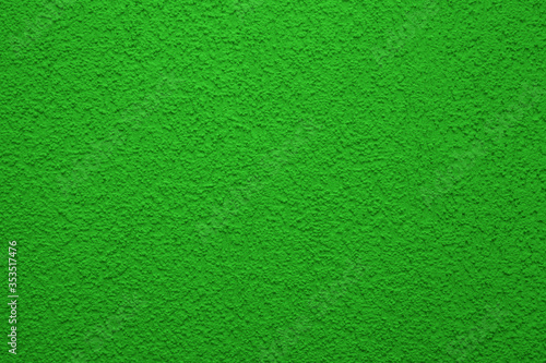 Bright, colorful concrete wall texture, painted background - green color. Wallpaper plaster.