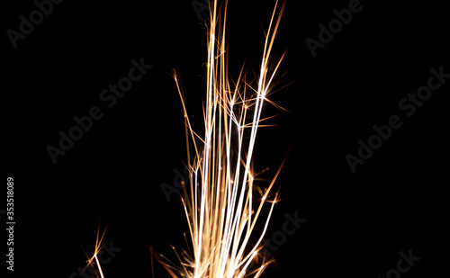 Closeup to a Lighter sparkles in darkness with black background. Energy and light concept