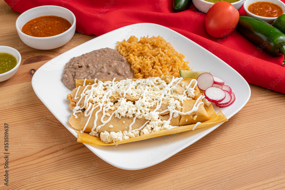 Tamale made with corn masa and filled with meat. Tamales topped with