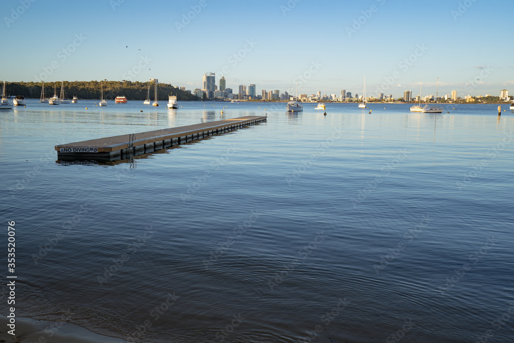A calm morning at Matilda Bay Reserve, Perth. The city can be seen in the background with boats in the bay. 