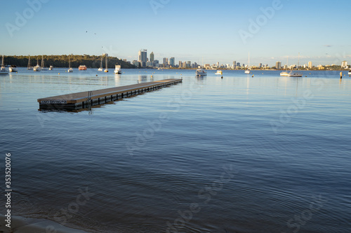 A calm morning at Matilda Bay Reserve, Perth. The city can be seen in the background with boats in the bay.  © Sky Perth